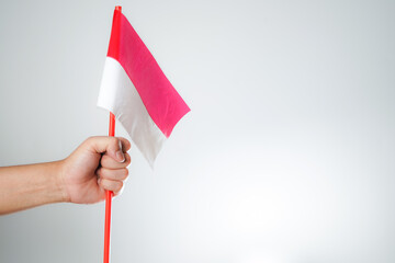 hands waving the flag excited to celebrate Indonesia's independence day on August 17