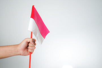 hands waving the flag excited to celebrate Indonesia's independence day on August 17