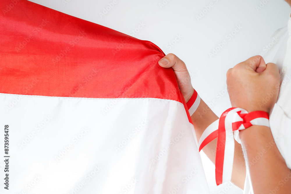 Wall mural excited men holding flags celebrating indonesia's independence day