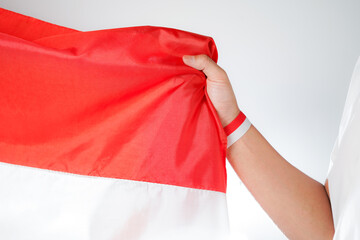 Excited men holding flags celebrating Indonesia's independence day