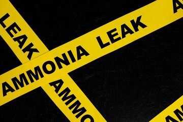 Ammonia gas leak or leakage caution danger and warning concept. Yellow barricade tape with word in...