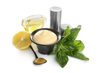 Bowl of fresh mayonnaise and ingredients on white background