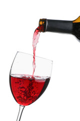 Pouring of exquisite wine from bottle into glass on white background