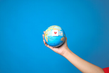Hand Holding Globe With Red Heart Symbol Plaster. Blood Donation Concept