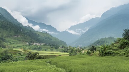 Obraz premium A sweeping view of a majestic mountain range with a small village nestled in the valley capturing the vastness of natural landscapes