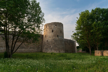 View of the Izborsk fortress wall and Ryabinovka Tower on a sunny summer day, Izborsk, Pechersk district, Pskov region, Russia