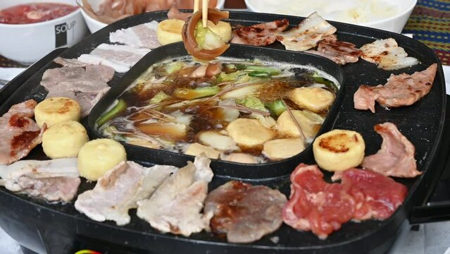 Footage of people enjoying their party with Korean BBQ and Shabu Shabu dinner.