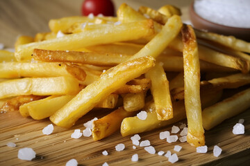 French fries on wooden board with some salt on side. Generative AI