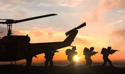 Military helicopter special force commando unit drop-off at sunset