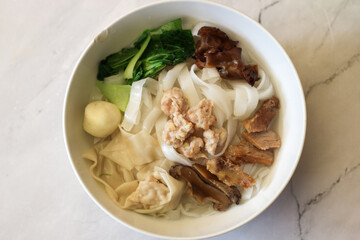 top of view soup kwetiau or kwetiaw kuah .