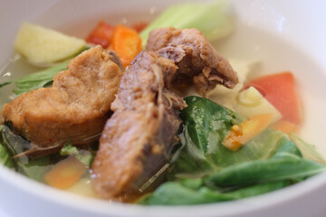 close up image of pork vegetable soup. indonesian chinese cuisine.