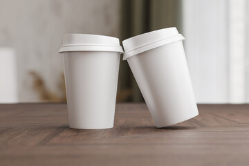 Two white take away coffee cup for mockup presentation branding design rendering minimalist blank close up with moody lighting calm and cozy engaging product display or disposable cup concept
