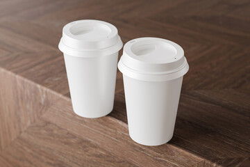 Two white take away coffee cup for mockup presentation branding design rendering minimalist blank close up with moody lighting calm and cozy engaging product display or disposable cup concept