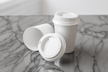 Two white take away coffee cup for mockup presentation branding design rendering minimalist blank close up with moody lighting calm and cozy engaging product display or disposable cup concept