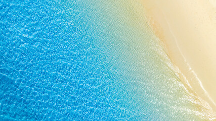 Top view nature of the beach and sea Summer with sunshine sandy beaches, clear blue waters sparkling against the blue sky. on an island with good ecology and environment Background for summer vacation