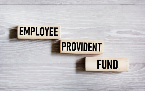 Wooden blocks with the inscription Employees' Provident Fund. Beautiful gray background, copy space. Business and EPF, employee provident fund concept.