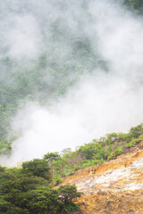 Landscape of Sikidang crater in Dieng, Indonesia with smoke of sulfur. Beautiful scenic in a mountain with sulfur smoke