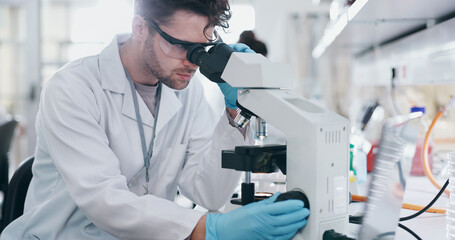 Test, research and man with microscope, science and check experiment for cancer treatment. Person,...