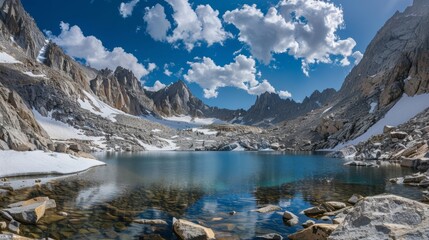 Obraz premium A rugged mountain pass with a glacial lake offering breathtaking views and a refreshing location for an ice bath.