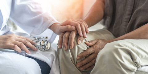 Arthritis or parkinson disease elderly patient, old aged senior woman holding geriatric doctor, cargiving nurse or family assistant's hand in hospice home for medical health care or mental therapy