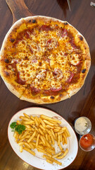 Pizza and french fries. Italian Pizza and French Fries on Table