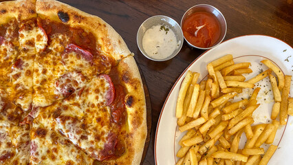 Pizza and french fries. Italian Pizza and French Fries on Table