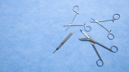 Flat lay of stainless forceps medical scissors placed on a blue background. Medical instruments . Medical Surgical Instrument. Equipment used in surgery.