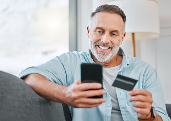 Relax, mobile and mature man with credit card on sofa for transaction, e commerce or online...