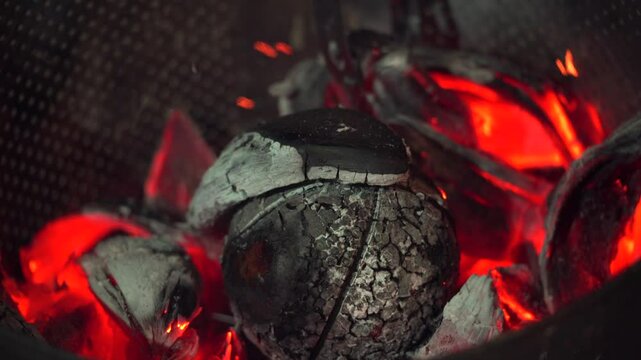 Roasted breadfruit in open fire, man covering breadfruit with  coconut husk, traditional Seychelles food, Mahe, Seychelles 4k 24fps 002