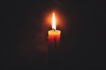 The candle flame emits a soft, warm light, illuminating the surroundings. The candlestick is simple and elegant, with wax dripping down the sides, creating a calm and peaceful atmosphere.