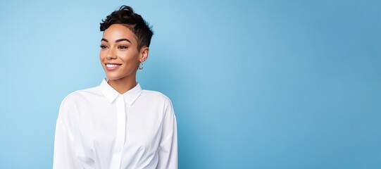 A woman with short hair and a white shirt is smiling at the camera