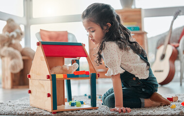 Girl, dollhouse and child thinking in home, games and fantasy for brain development on floor....