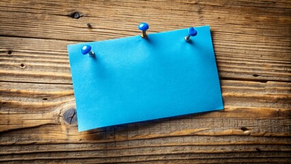 A solitary, bright blue rectangular note with a slight curl stuck to a distressed wooden board amidst scattered pins.