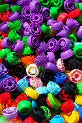 Obraz premium Plastic lids. Lots of colorful caps. Industry, ecology, plastic processing