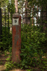 Number 9 in black on an old fence post