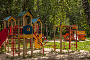 A children Colorful playground on yard in the park. the green grass