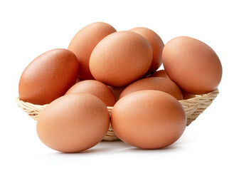 Front view of fresh brown chicken eggs in stack in wicker basket isolated with clipping path and shadow in png file format