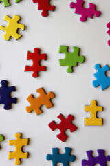 Colorful jigsaw puzzle pieces on white background. Flat lay.