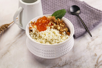 Curd with granola and orange jam