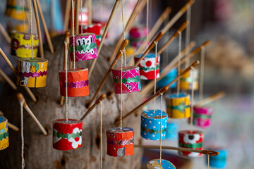 Thai retro toy called "Jak ka jan ".  Sound like a cicada bug when swing it. It make from bamboo,clay, small rope and color paper. © Silapavet