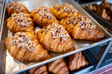 Delicious  Sweet almond croissants on metal prate. Fresh made bakery