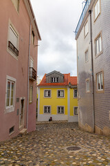 The charming streets of Lisbons Old Town feature colorful buildings, cobblestone paths, and a classic European allure, creating a picturesque scene reflecting the citys historic and scenic beauty
