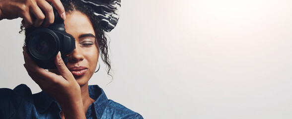 Camera, woman and photographer in studio with mockup space for creative photography career. Art, banner and female person from Brazil with dslr equipment for magazine photoshoot by white background.