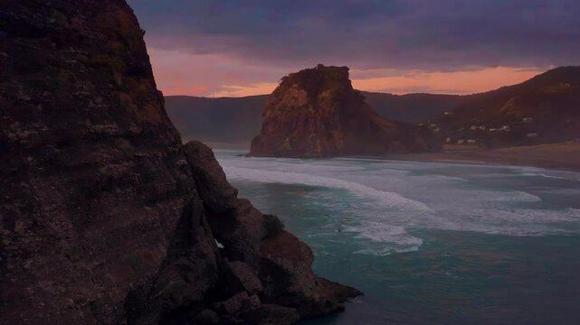 Dreamlike heavenly ocean of waves crassing on the shore at sunset. Piha, Auckland, New Zealand.