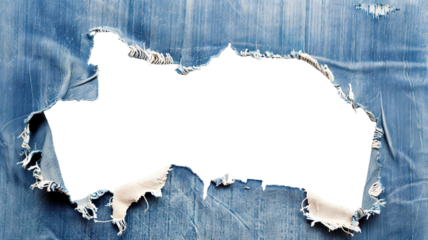 Large hole in worn blue denim fabric with frayed edges, cut out