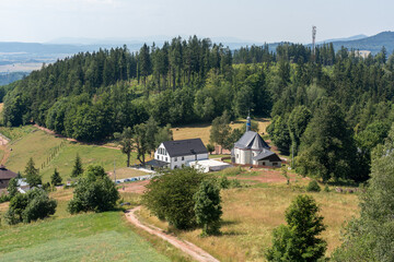 View from the mountain of an old church in a field among the mountains. Beautiful mountain landscape. High quality photo