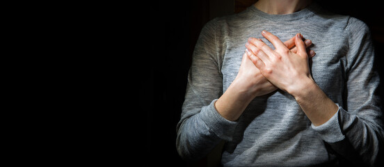 Hands folded in prayer over the heart