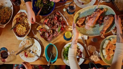 Friendsgiving Party with People Passing Plates of Food - 4K Ultra HD Top Down Shot