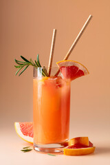 Summer cocktail with grapefruit, rosemary, and ice.