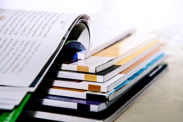 stack of books open on table